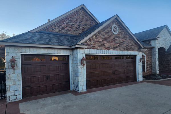 A Comprehensive Guide to Choosing the Perfect Garage Door for Your Oklahoma Home- image of a house with two new garage doors installed.