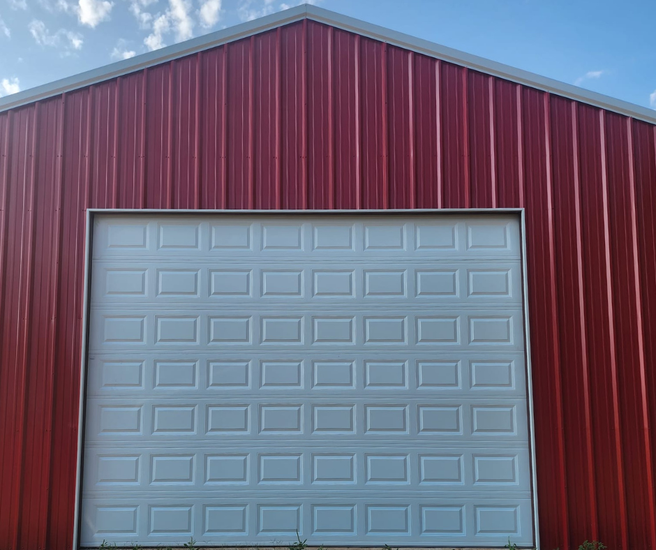 commercial garage door services by total door solutions in oklahoma - image of red commercial building with new white panel garage door install