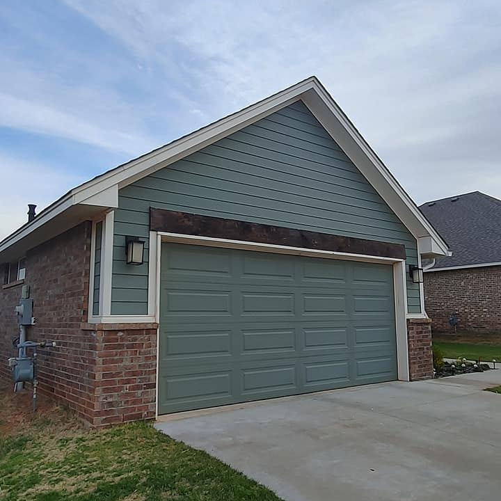 About Total Door Solutions in Oklahoma - image of new garage door install. paneling of garage door is green