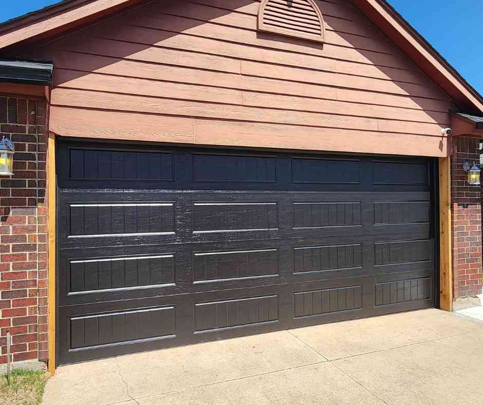 garage door repair in Mustang by total door solutions - image of home with a new garage door installed