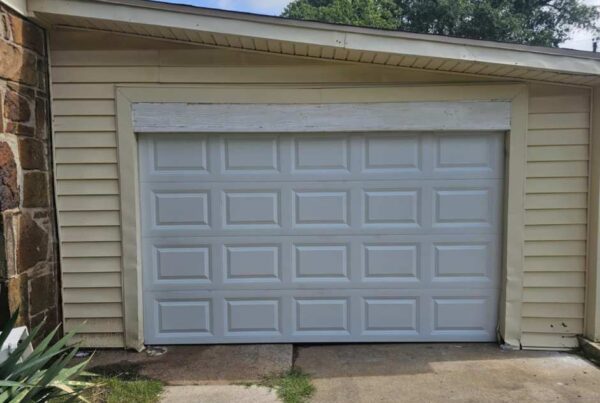 Garage Door Repair vs Replacement: 7 Key Signs You Need to Know by Total Door Solution. Image of recently installed garage door with white panels
